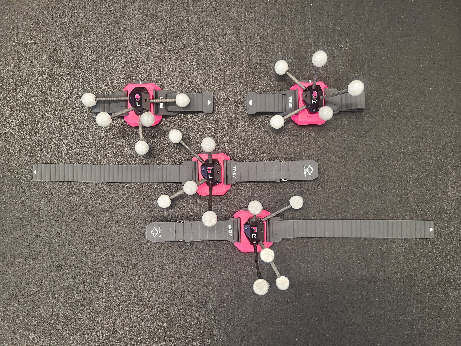 The four trackers in pink player colour laid out on the arena floor