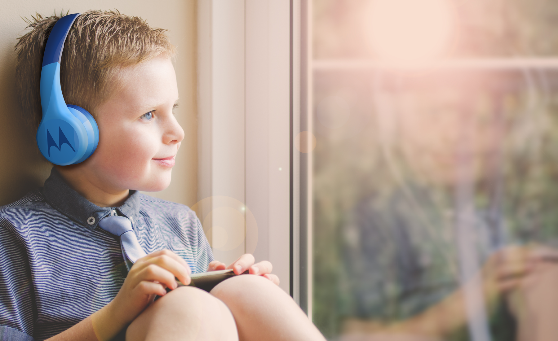 Child wearing blue Motorola headphones