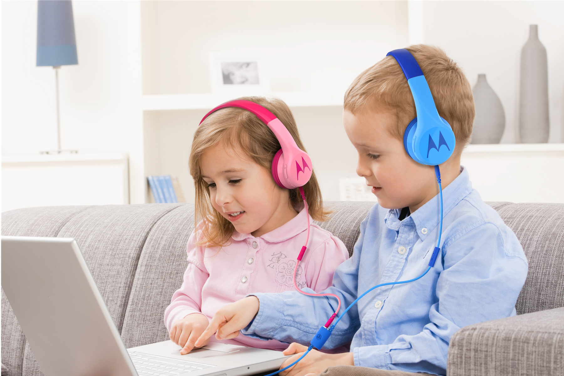 Children using blue and pink Motorola Squads 300 kids headphones