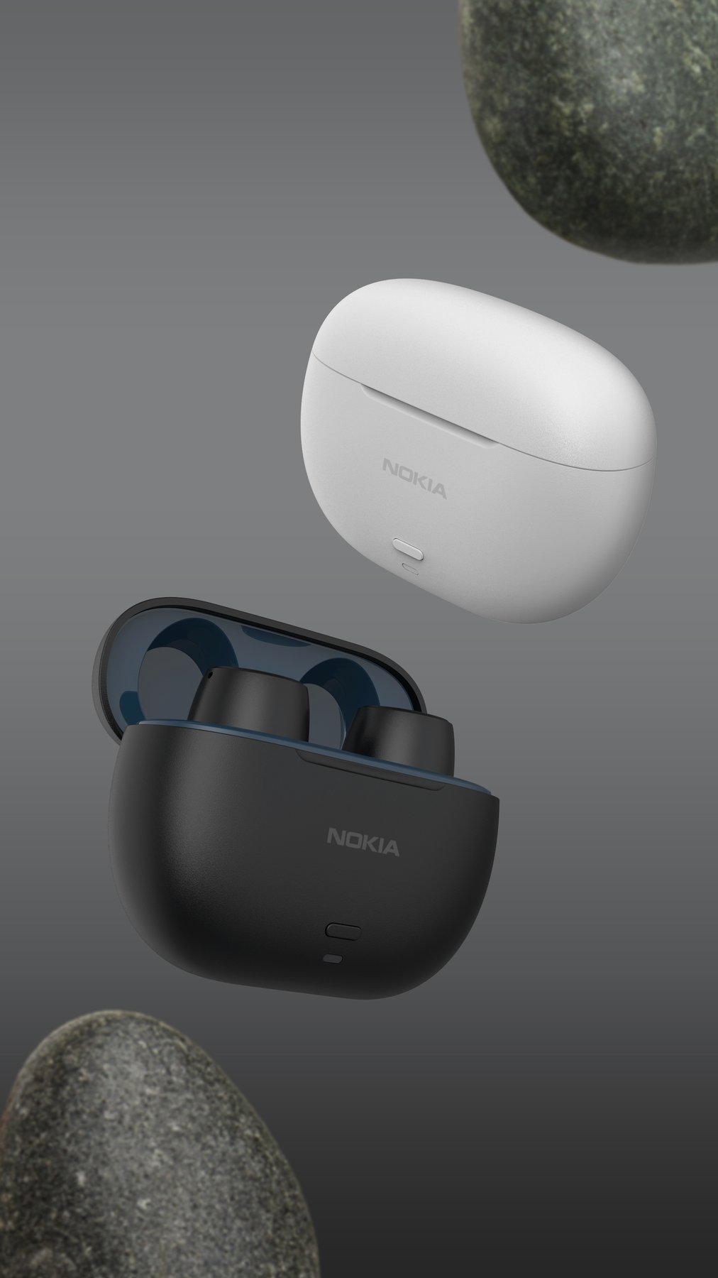 Black and white charging cases among stones