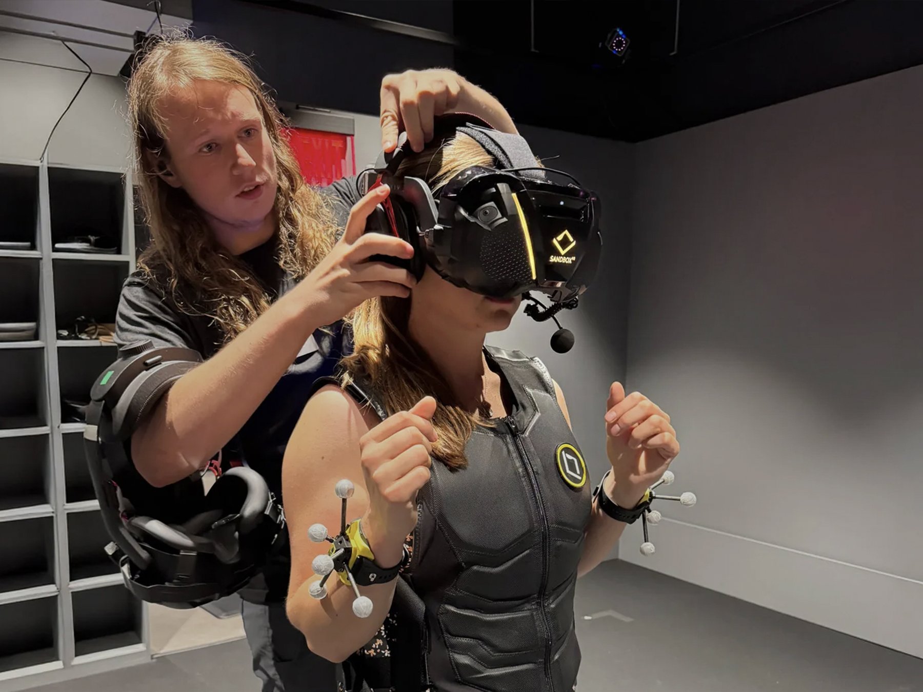 Store staff fitting a headset onto a player