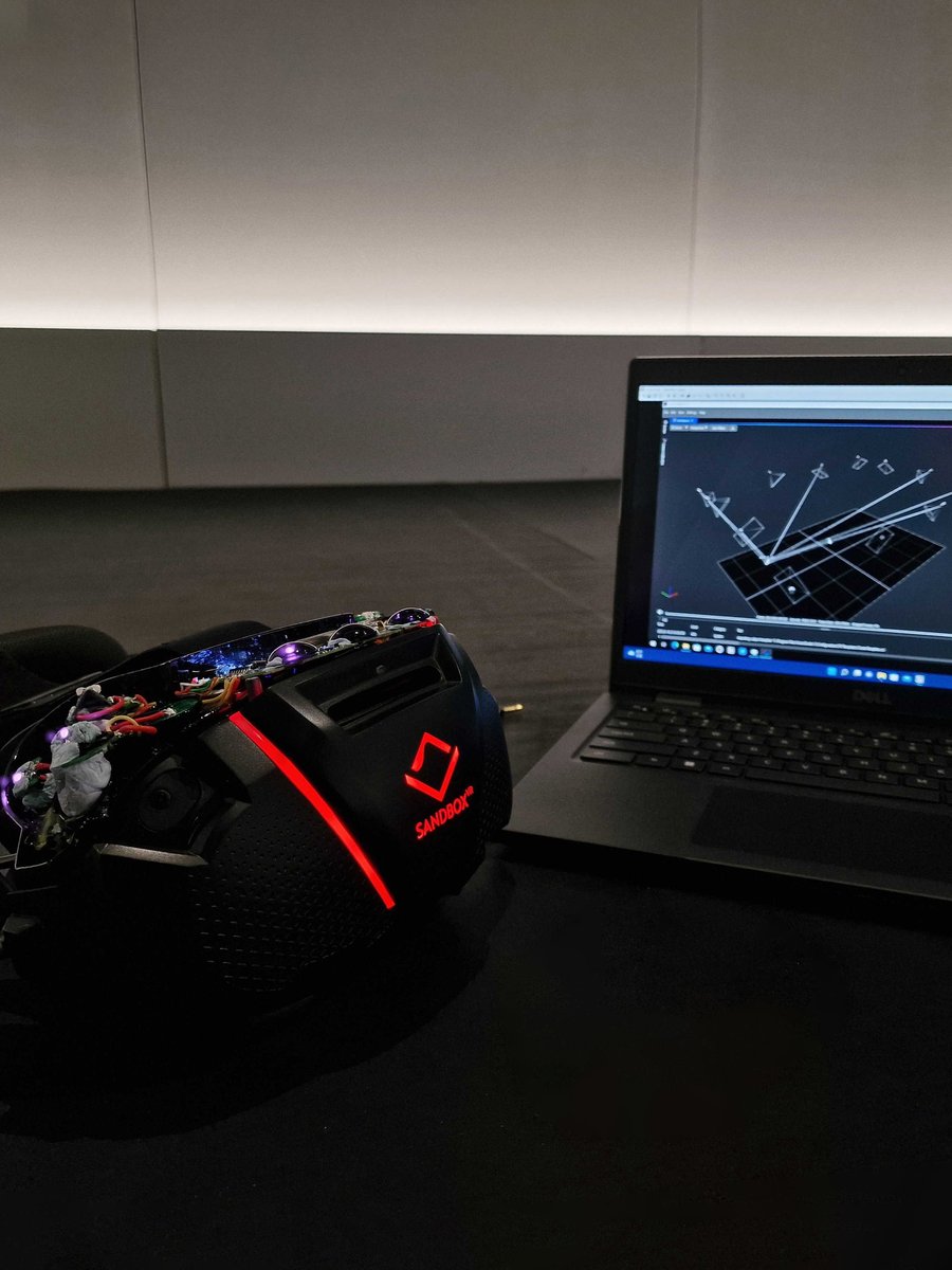 Prototype head tracker under test next to a laptop